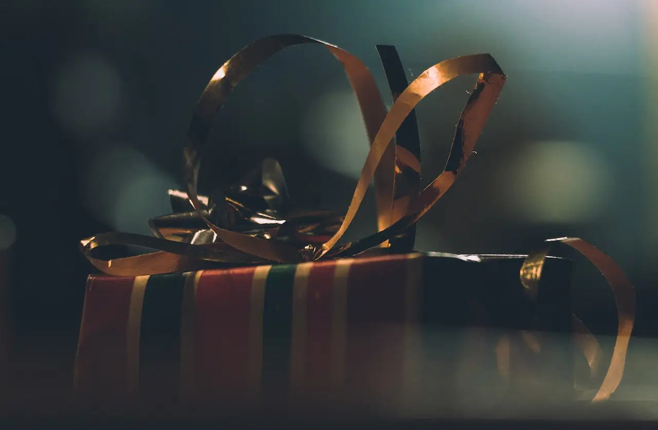 A wrapped present with golden ribbons