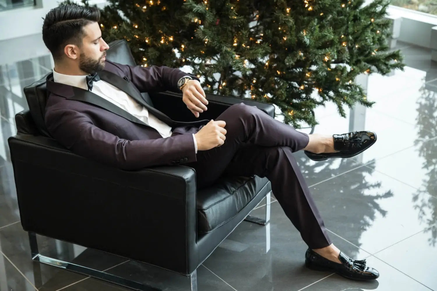 A gentleman wearing a tuxedo and checking his watch