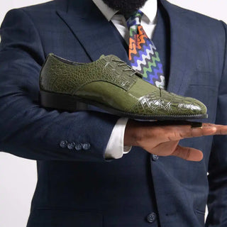 Olive green crocodile-patterned dress shoe.